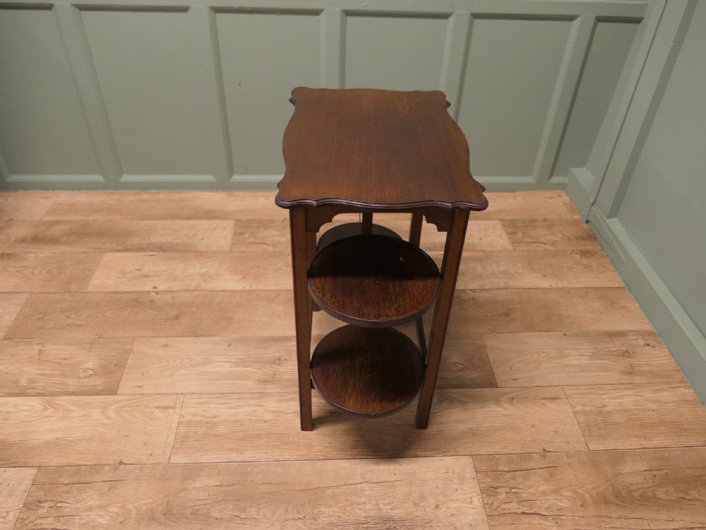 An Edwardian mahogany side table featuring a flat rectangular top and two side-mounted folding circular tiered cake stands. View V