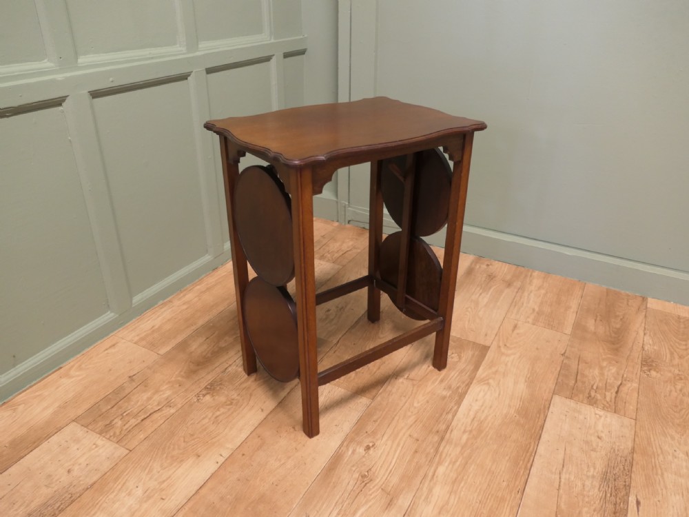 An Edwardian mahogany side table featuring a flat rectangular top and two side-mounted folding circular tiered cake stands. View VII