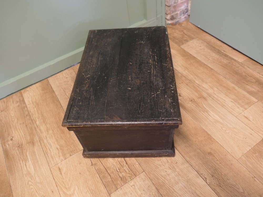 A rectangular dark stained pine carpenters box with a hinged lid and a moulded plinth base. View IV