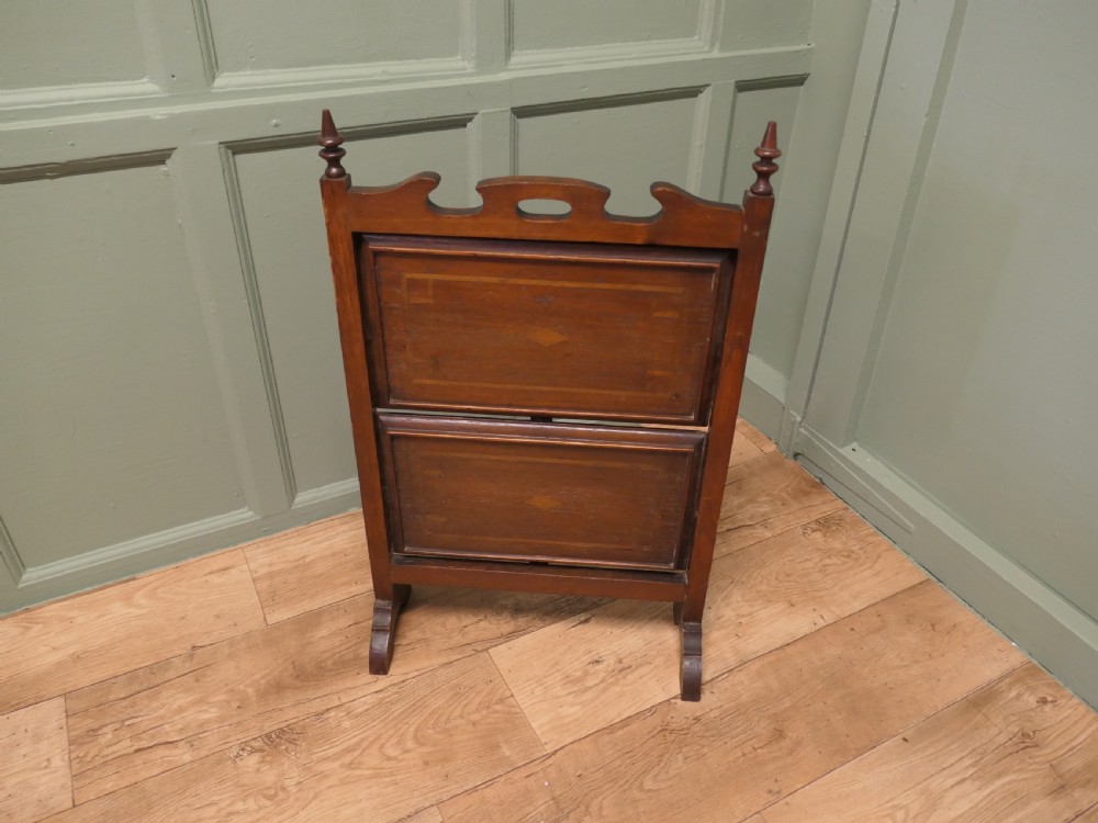 A warm brown mahogany metamorphic fire screen featuring turned finials that transforms into a two-tiered occasional butler table. View II
