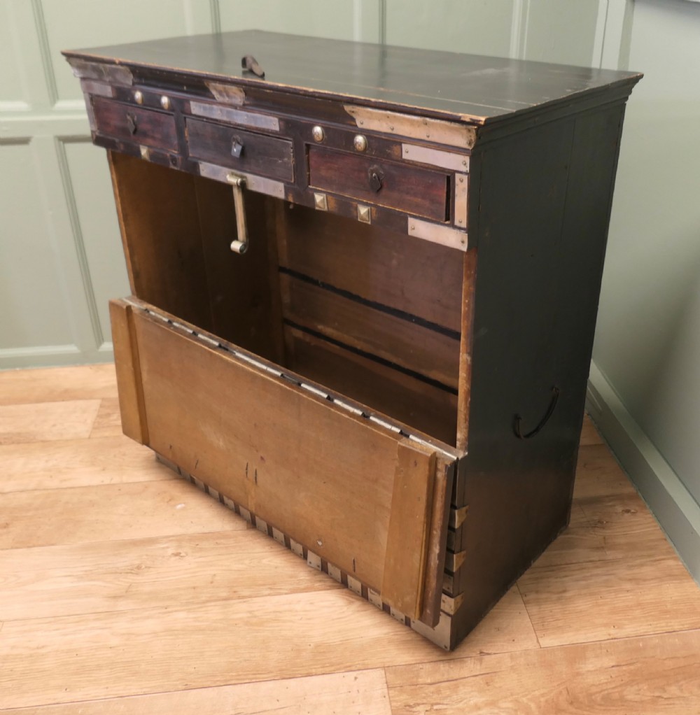 A dark brown wooden Korean Bandaji chest adorned with elaborate silver-coloured brass plating, geometric studs, etched metal panels, and three top drawers. View V