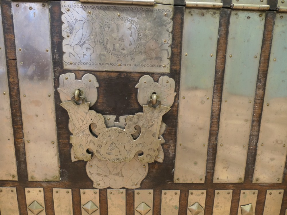A dark brown wooden Korean Bandaji chest adorned with elaborate silver-coloured brass plating, geometric studs, etched metal panels, and three top drawers. View VII