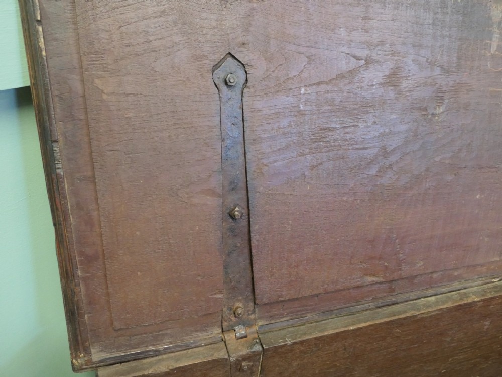 A rectangular carved elm wood storage coffer featuring decorative pierced brass corner mounts and a central lockplate above an ornate carved apron. View II