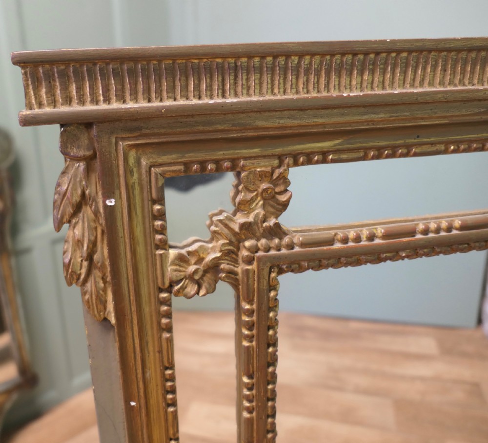 A large rectangular French giltwood cushion mirror featuring beaded trim moulding and marginal border mirror plates. View II
