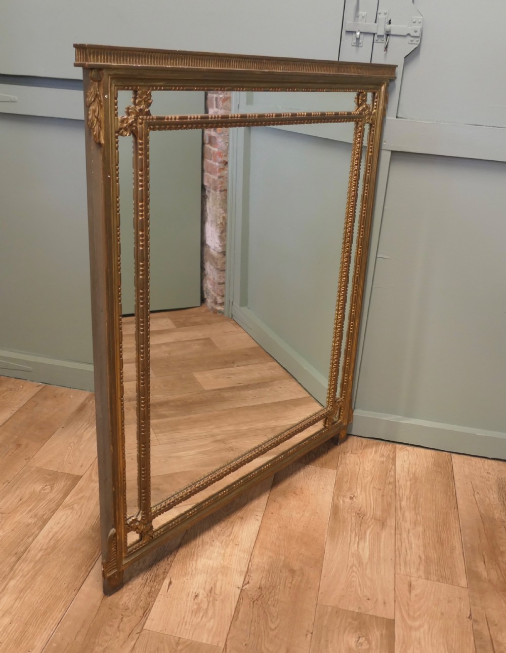 A large rectangular French giltwood cushion mirror featuring beaded trim moulding and marginal border mirror plates. View V