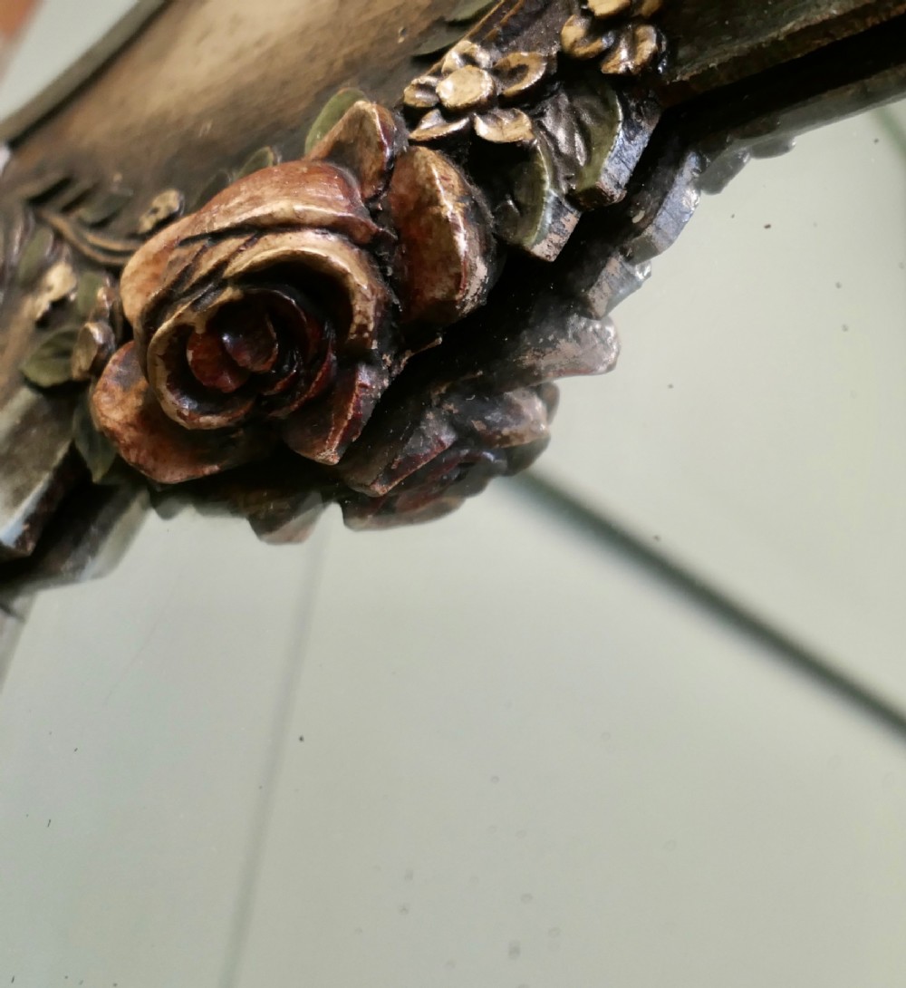 A 19th-century Northern Italian Baroque style wall mirror featuring a carved wooden frame with a scallop shell crest and polychrome floral carvings. View III
