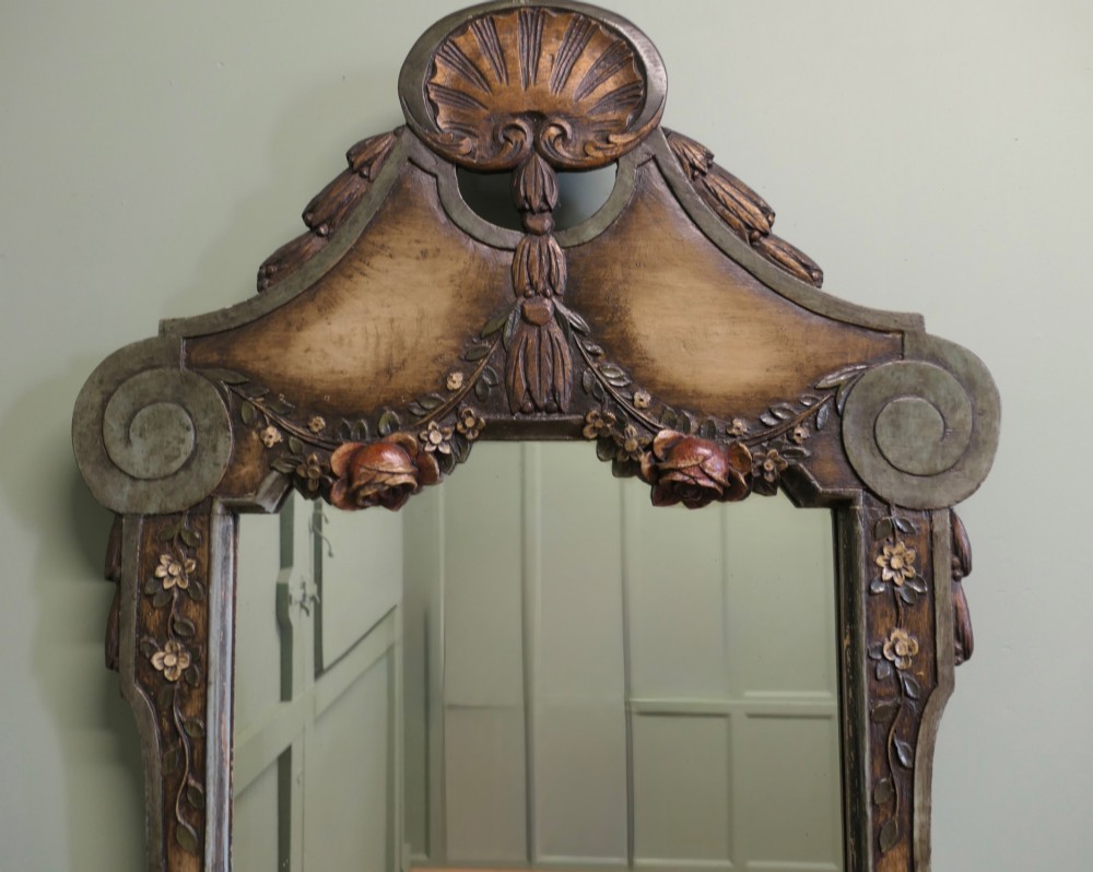 A 19th-century Northern Italian Baroque style wall mirror featuring a carved wooden frame with a scallop shell crest and polychrome floral carvings. View VI