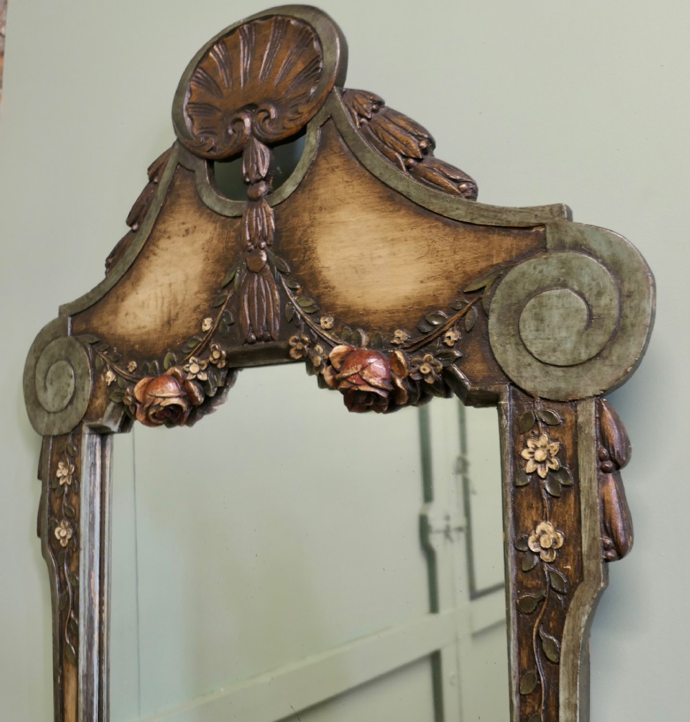A 19th-century Northern Italian Baroque style wall mirror featuring a carved wooden frame with a scallop shell crest and polychrome floral carvings. View VII