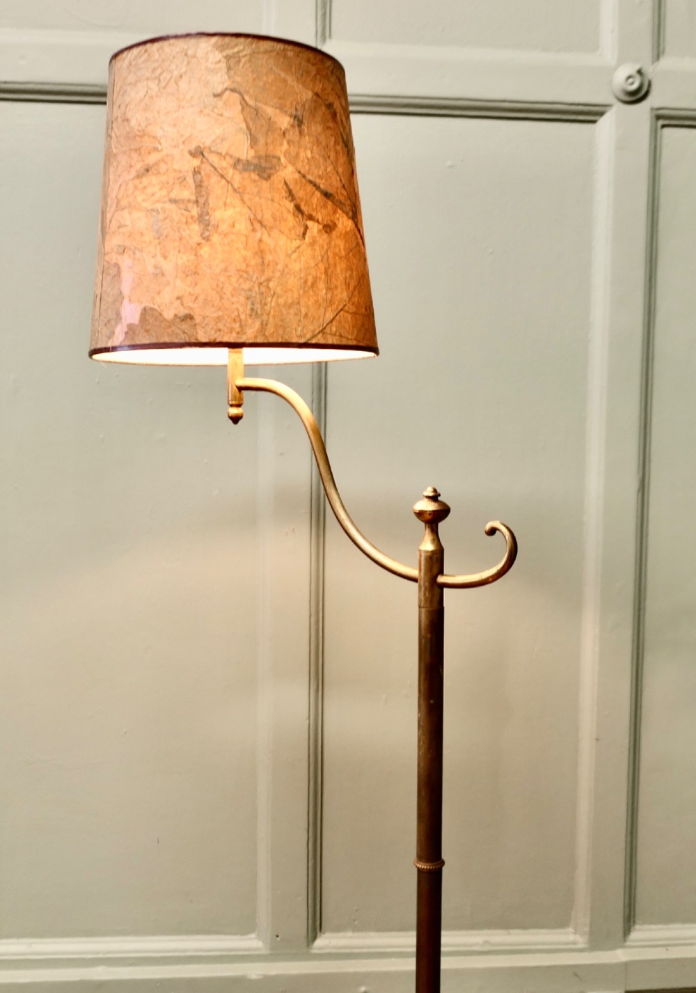 A French Arts and Crafts brass floor lamp featuring a slender stem, tripod base, curved adjustable arm, and a mottled parchment shade. View IV