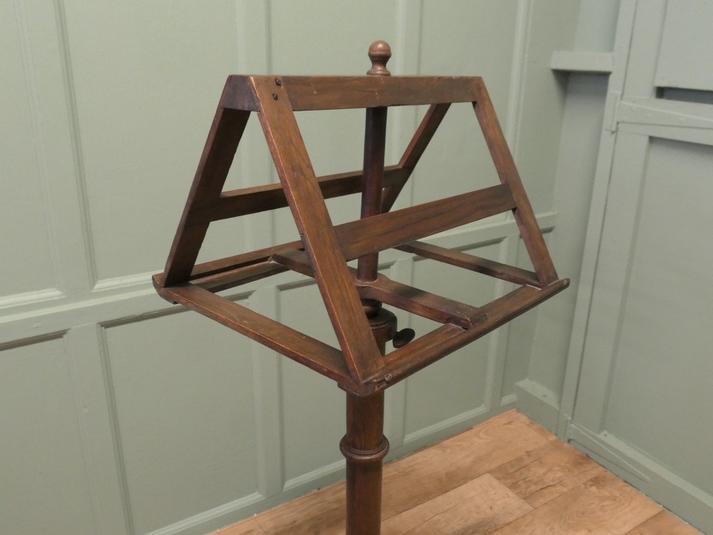 A 19th-century oak duet music stand featuring a double-sided adjustable rack resting on a turned column and tripod base. View II