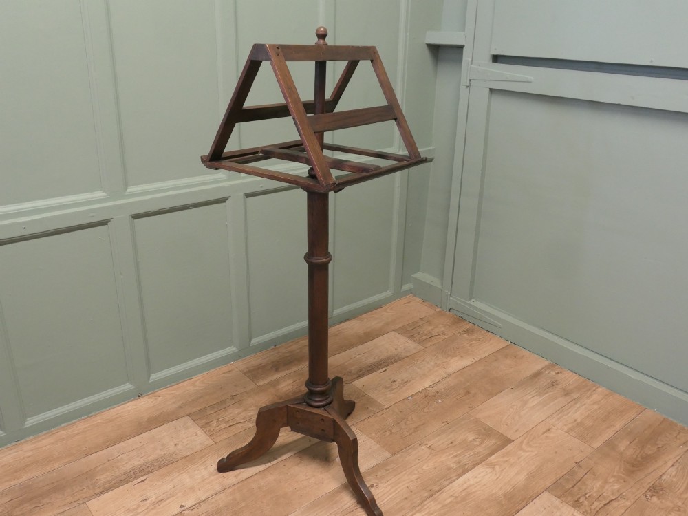 A 19th-century oak duet music stand featuring a double-sided adjustable rack resting on a turned column and tripod base. View IV