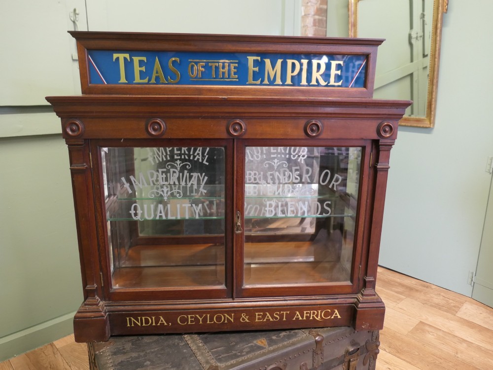Victorian mahogany shop display cabinet featuring gilded signage reading Teas of the Empire and acid-etched glass doors.