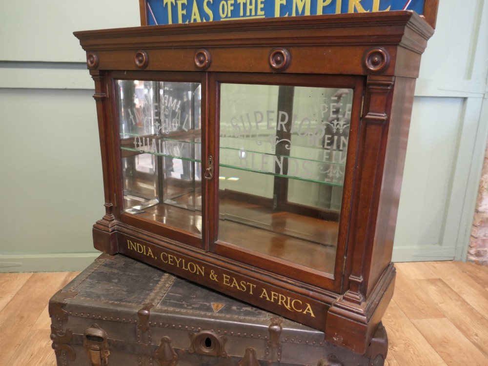 Victorian mahogany shop display cabinet featuring gilded signage reading Teas of the Empire and acid-etched glass doors. View VI