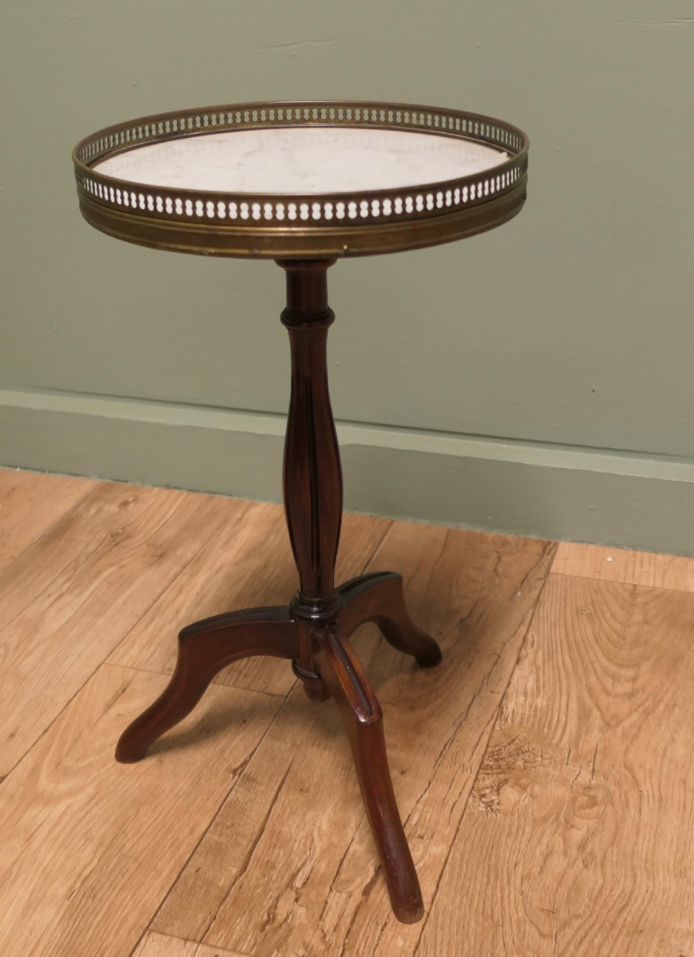 A French Napoleon III style circular wine table with a white marble top, pierced brass gallery, turned central wood column, and tripod legs. View II