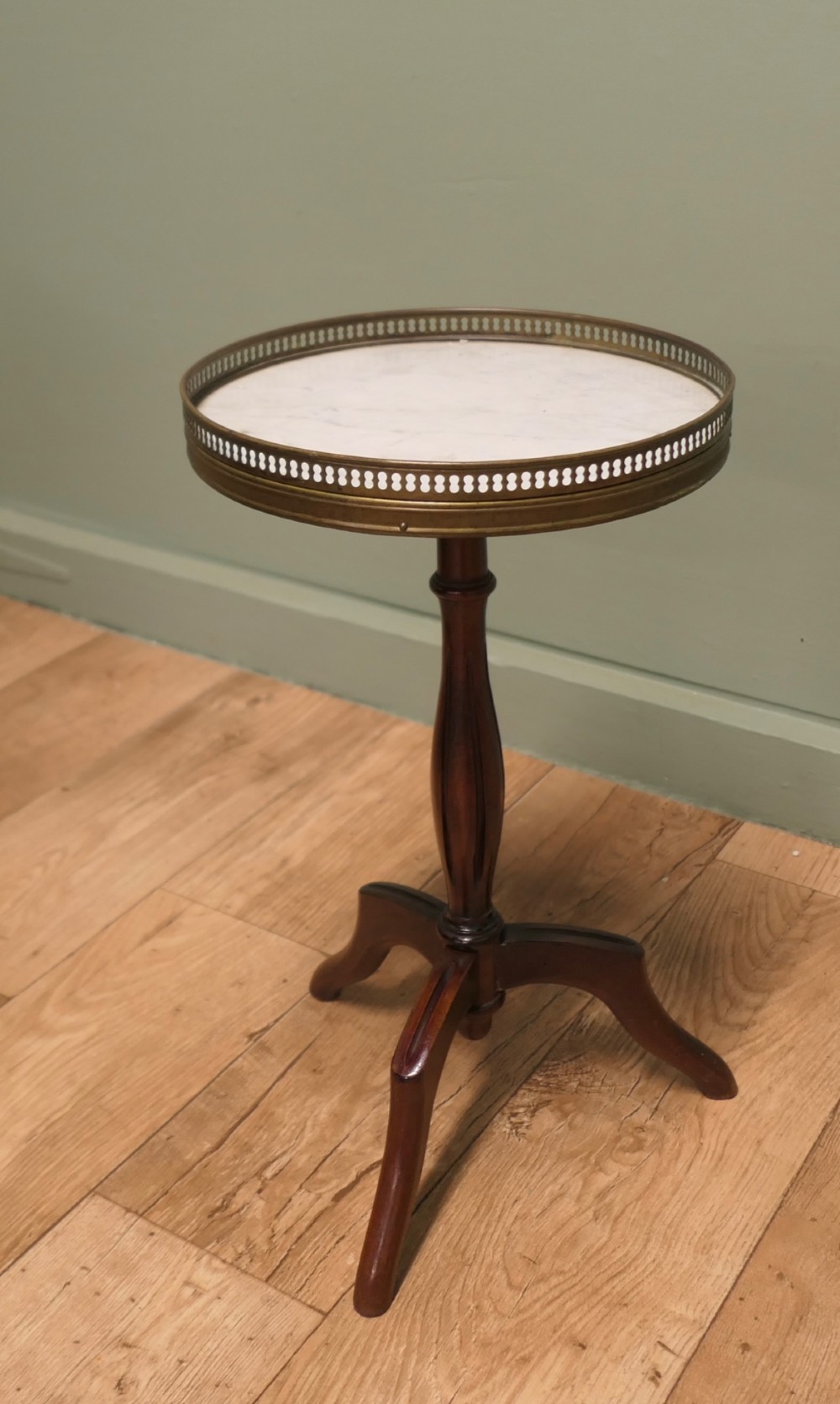 A French Napoleon III style circular wine table with a white marble top, pierced brass gallery, turned central wood column, and tripod legs. View III