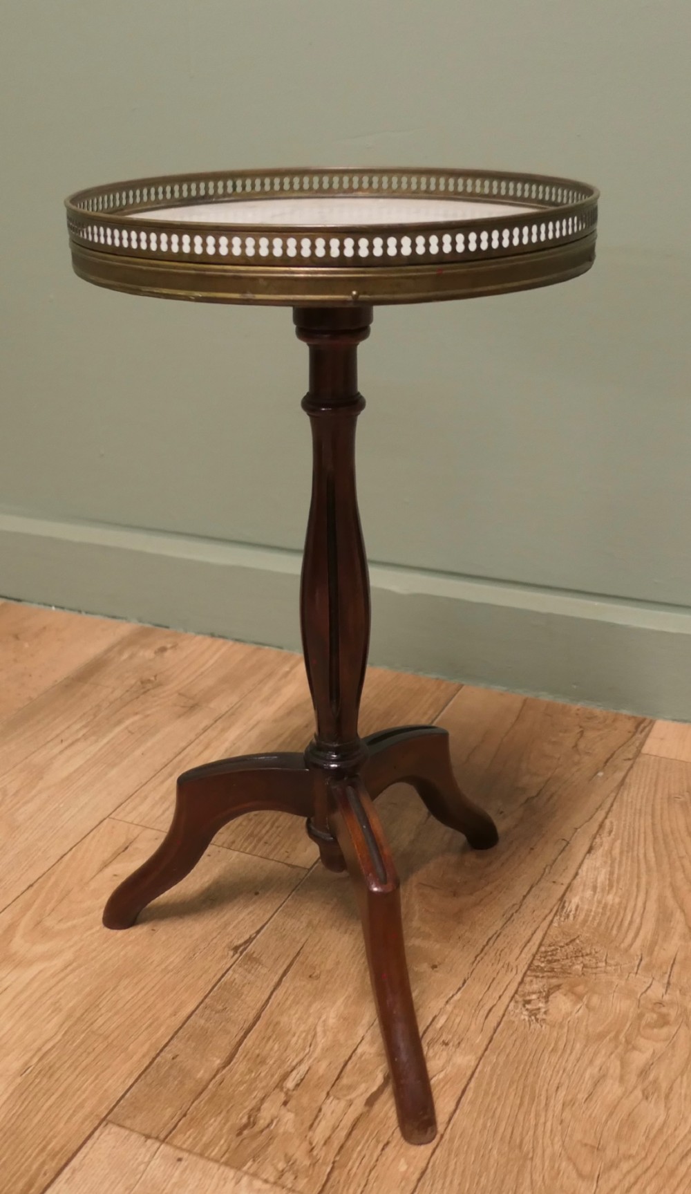 A French Napoleon III style circular wine table with a white marble top, pierced brass gallery, turned central wood column, and tripod legs. View V