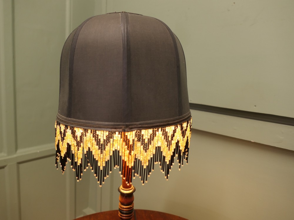 A wooden table lamp featuring a turned barley twist stem and a dark dome shade adorned with glass bead fringe. View IV