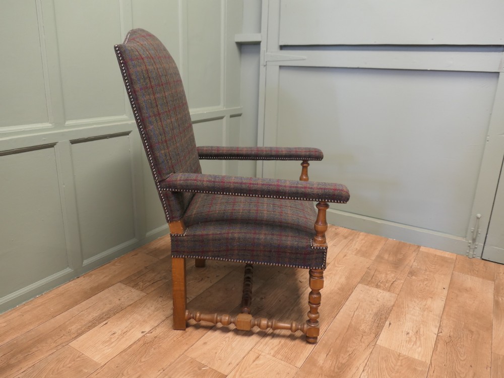 An upholstered high-back armchair with tweed plaid fabric, brass studding, and turned oak legs with stretchers. View IV