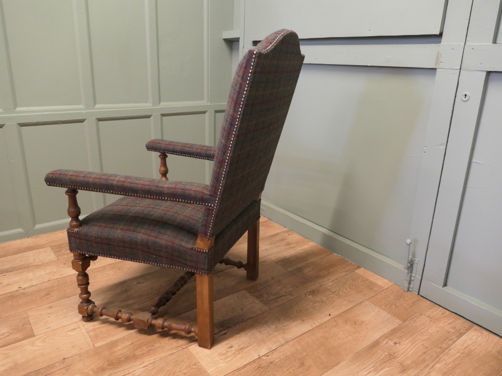 An upholstered high-back armchair with tweed plaid fabric, brass studding, and turned oak legs with stretchers. View VII