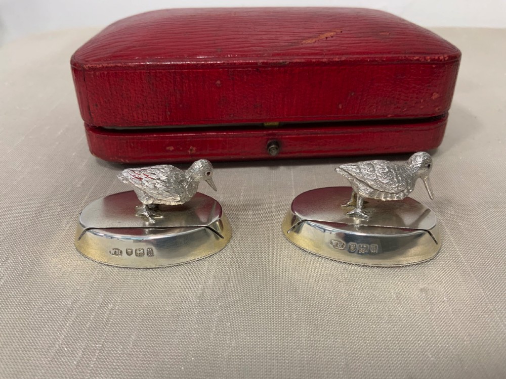 A pair of Edwardian sterling silver woodcock menu holders presented inside a red fitted silk-lined case. View II