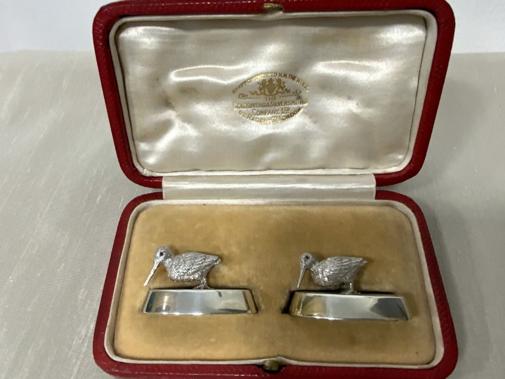 A pair of Edwardian sterling silver woodcock menu holders presented inside a red fitted silk-lined case.