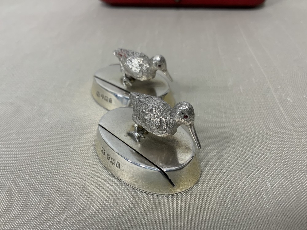 A pair of Edwardian sterling silver woodcock menu holders presented inside a red fitted silk-lined case. View VII