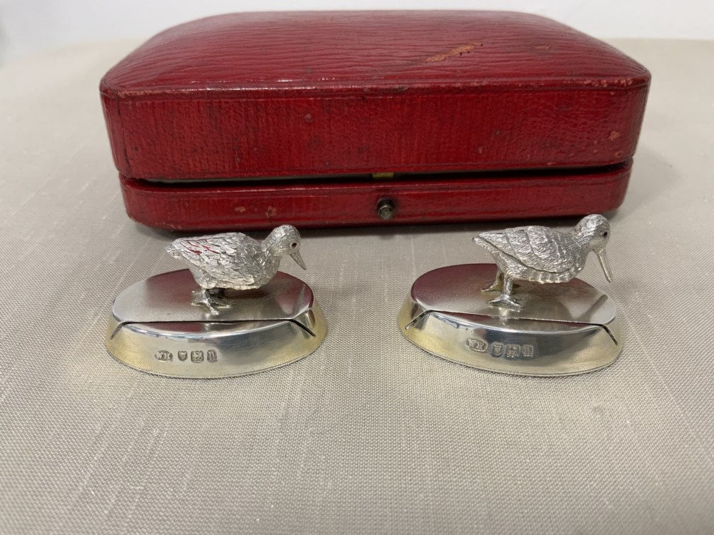 A pair of Edwardian sterling silver woodcock menu holders presented inside a red fitted silk-lined case. View IX