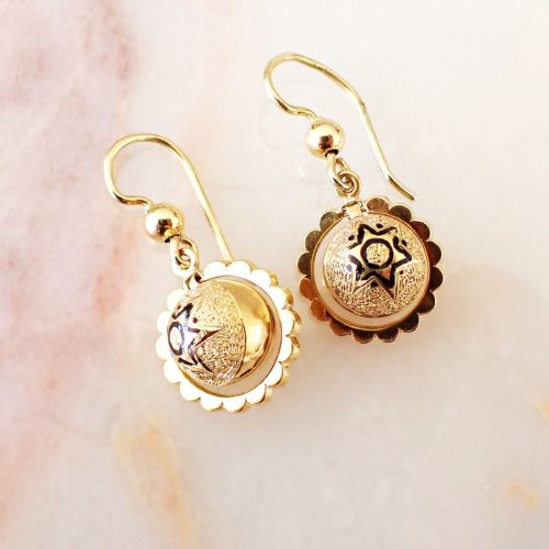 fig 2. A pair of Victorian 15ct yellow gold drop earrings featuring central textured domes decorated with black enamel star motifs inside scalloped circular borders.