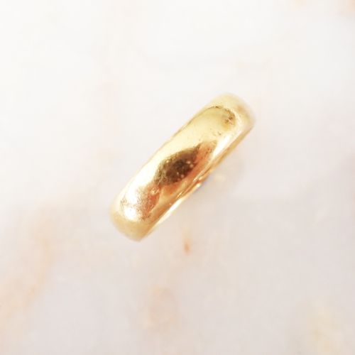 fig 1. A solid 22ct yellow gold band ring with visible internal hallmarks against a plain white background.