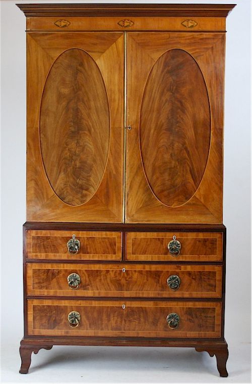 George 111 Figured Mahogany Oval Panelled Linen Press.