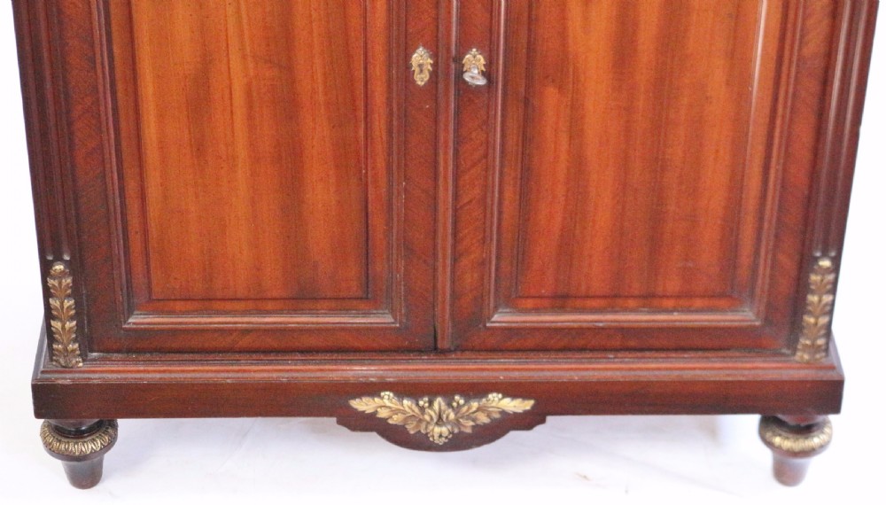 A tall Victorian mahogany open-top cabinet with two shelves over a two-door cupboard base fitted with gilt-metal mounts. View V