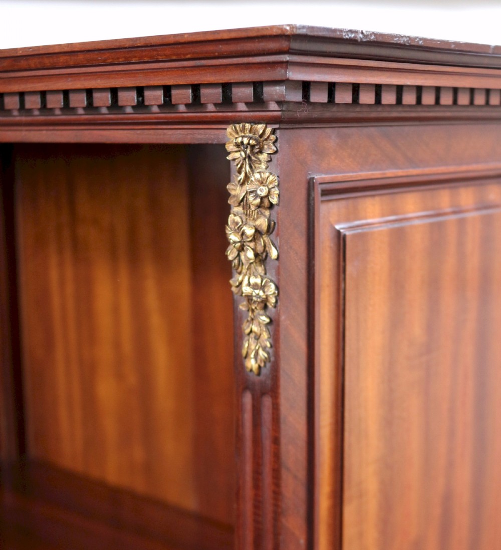 A tall Victorian mahogany open-top cabinet with two shelves over a two-door cupboard base fitted with gilt-metal mounts. View VI