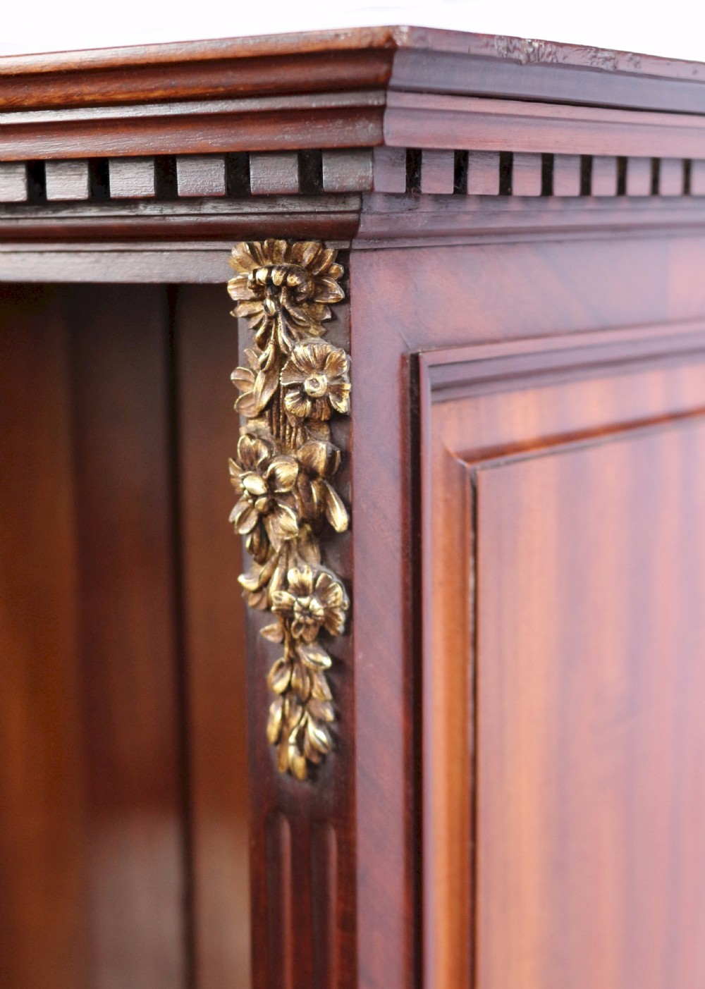 A tall Victorian mahogany open-top cabinet with two shelves over a two-door cupboard base fitted with gilt-metal mounts. View VII