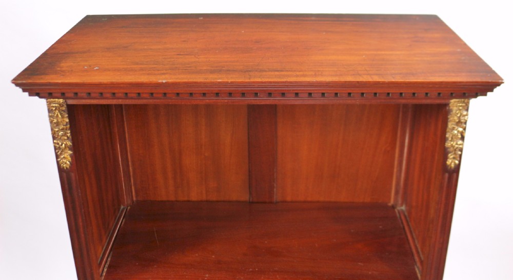 A tall Victorian mahogany open-top cabinet with two shelves over a two-door cupboard base fitted with gilt-metal mounts. View VIII