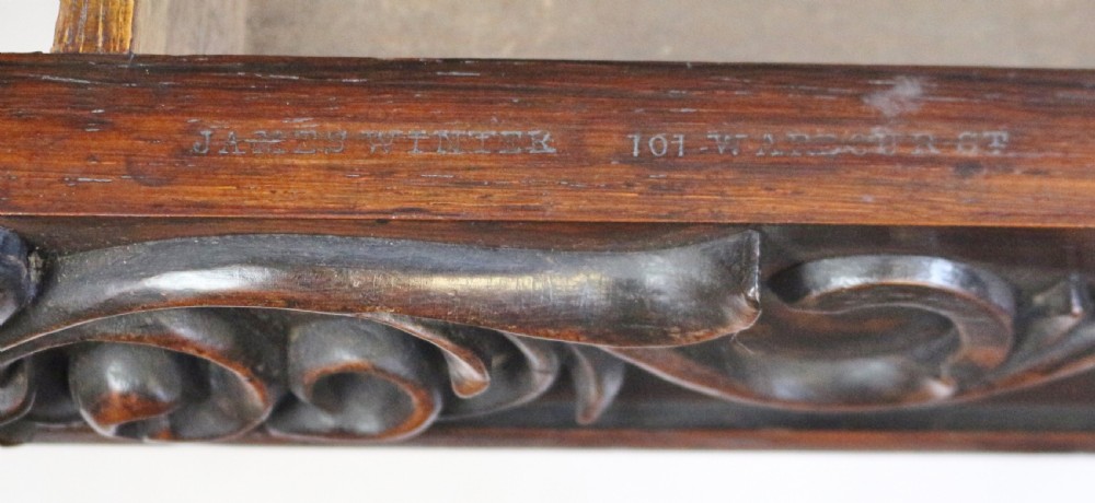 A William IV rosewood centre table featuring a rectangular top with rounded corners, a carved frieze, turned end supports, a low stretcher, and scroll feet. View XIII
