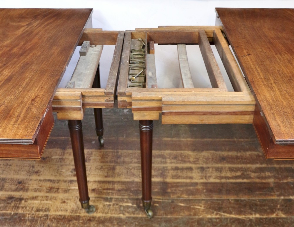 George 111 Mahogany 'Imperial' Action Extending Dining Table with 3 Extra Leaves.  View VII