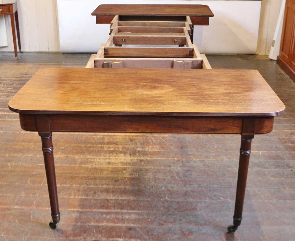 George 111 Mahogany 'Imperial' Action Extending Dining Table with 3 Extra Leaves.  View IX
