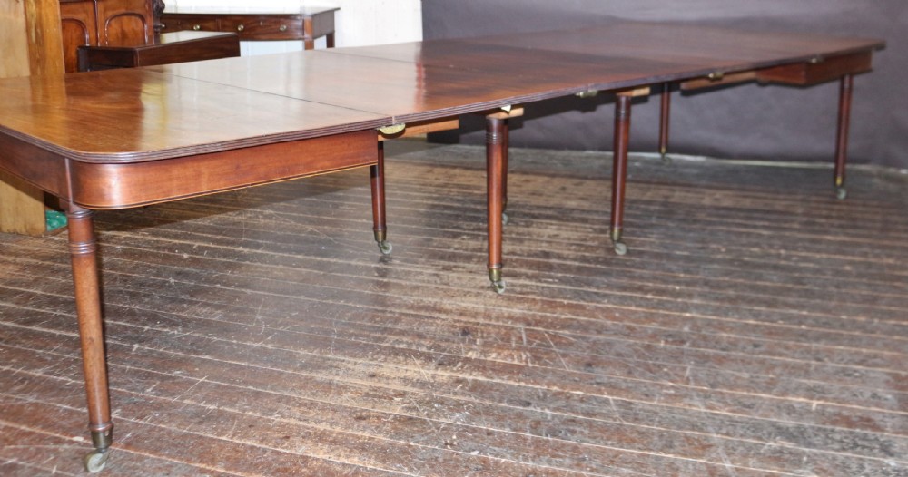 George 111 Mahogany 'Imperial' Action Extending Dining Table with 3 Extra Leaves.  View XIII