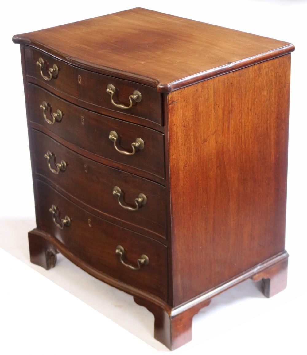 A George III mahogany serpentine chest of drawers featuring four drawers with brass swan-neck handles and bracket feet. View III