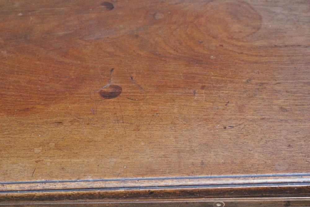 A George III mahogany chest of drawers featuring a pull-out brushing slide, two short drawers over three long graduated drawers with decorative brass handles, raised on bracket feet. View VI