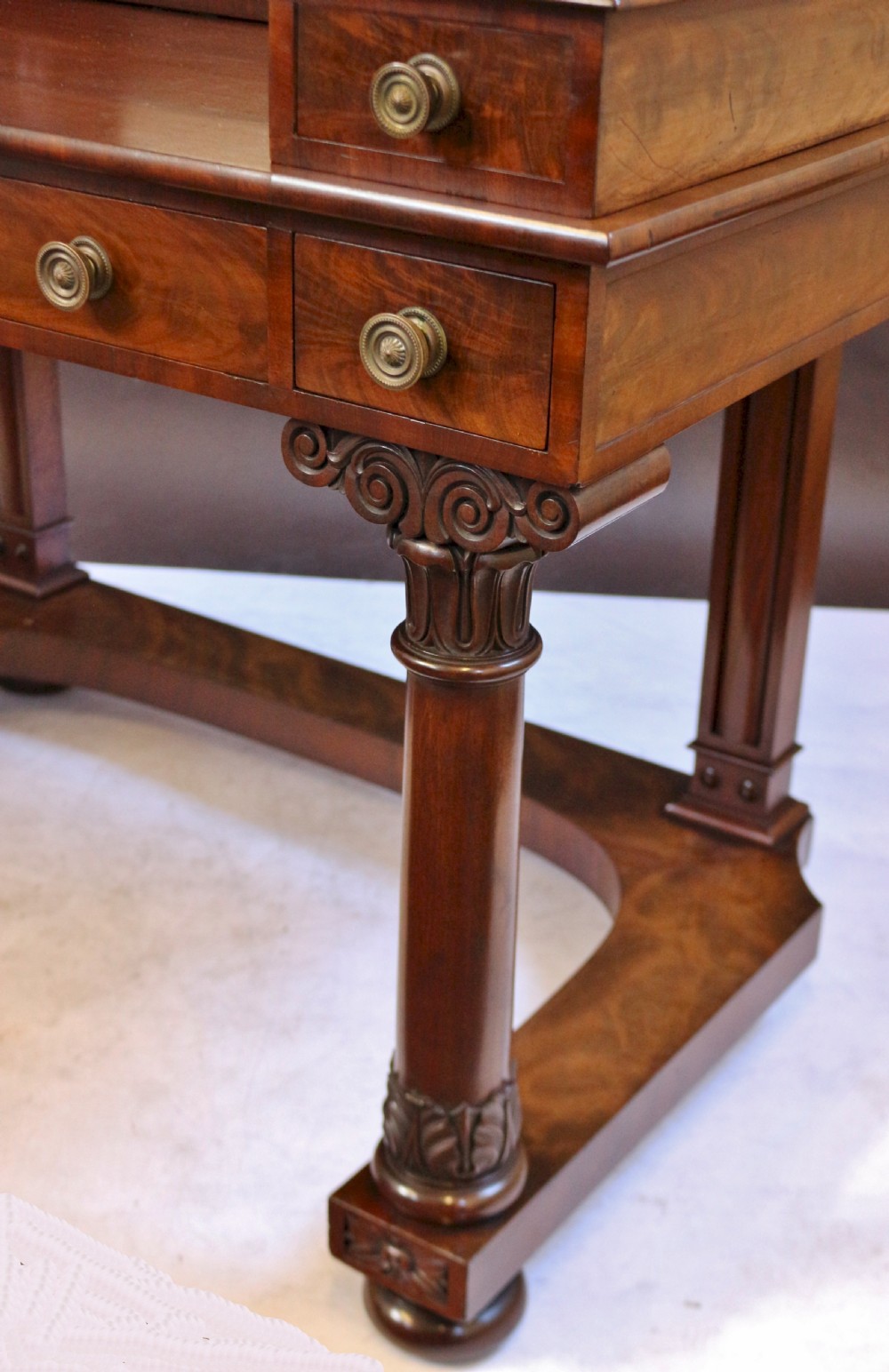 A William IV mahogany dressing table featuring an arched swivel mirror, brass sconces, upper drawers, and carved front columns on a plinth base. View VIII