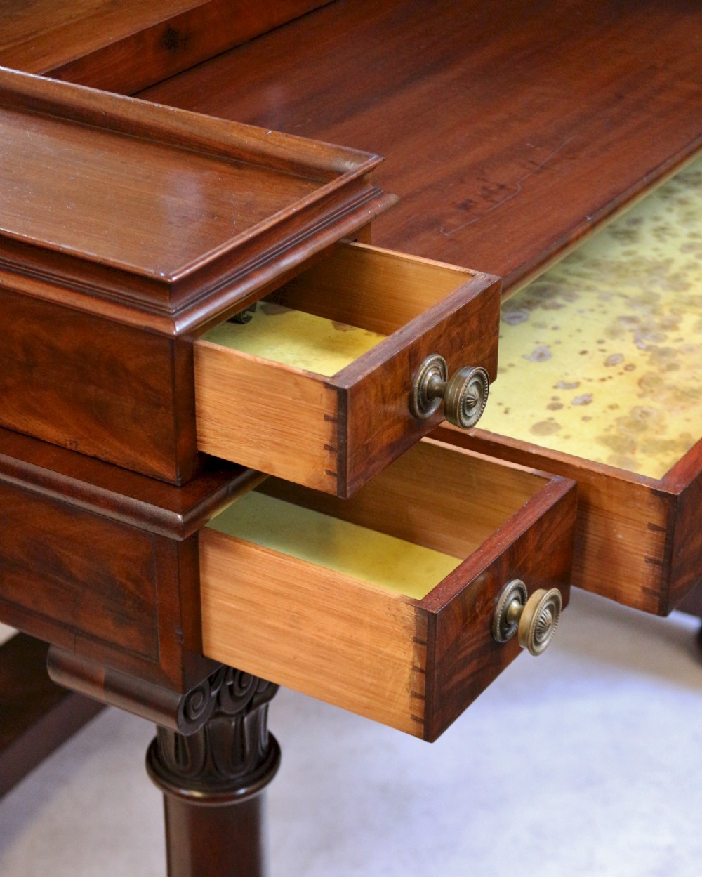 A William IV mahogany dressing table featuring an arched swivel mirror, brass sconces, upper drawers, and carved front columns on a plinth base. View IX