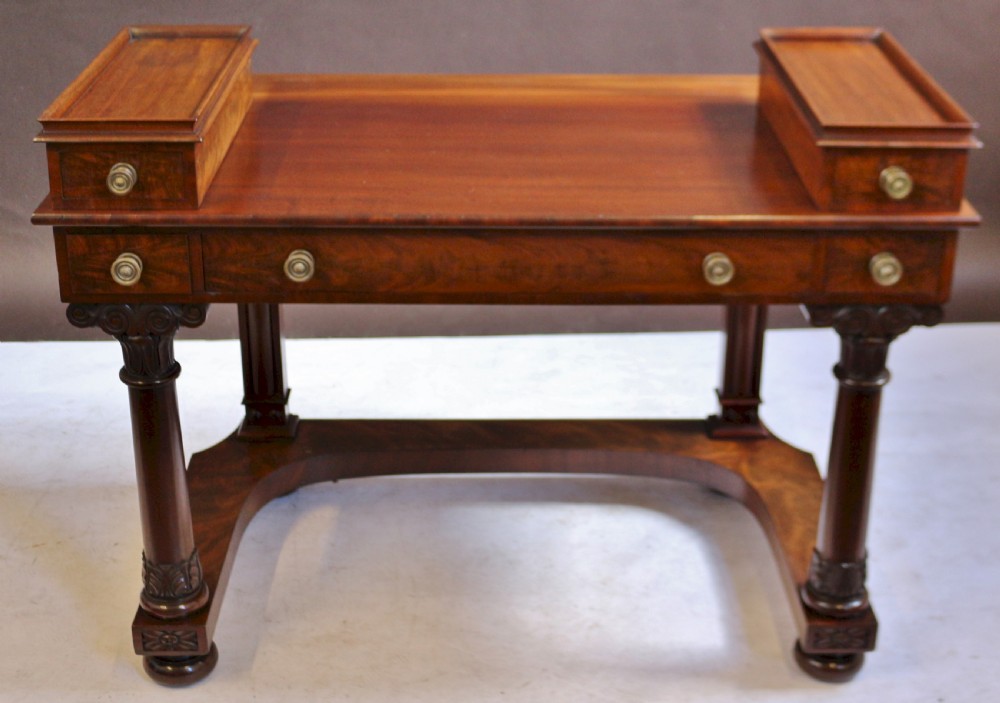 A William IV mahogany dressing table featuring an arched swivel mirror, brass sconces, upper drawers, and carved front columns on a plinth base. View XI