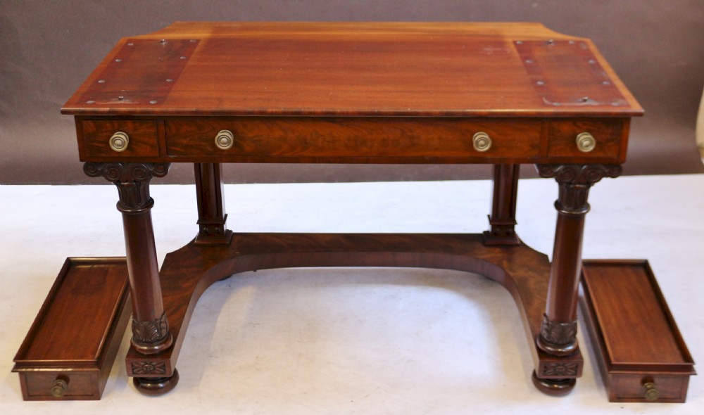 A William IV mahogany dressing table featuring an arched swivel mirror, brass sconces, upper drawers, and carved front columns on a plinth base. View XII