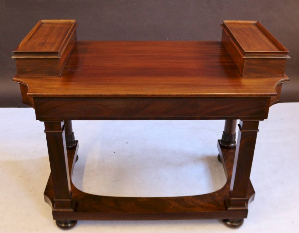 A William IV mahogany dressing table featuring an arched swivel mirror, brass sconces, upper drawers, and carved front columns on a plinth base. View XIII