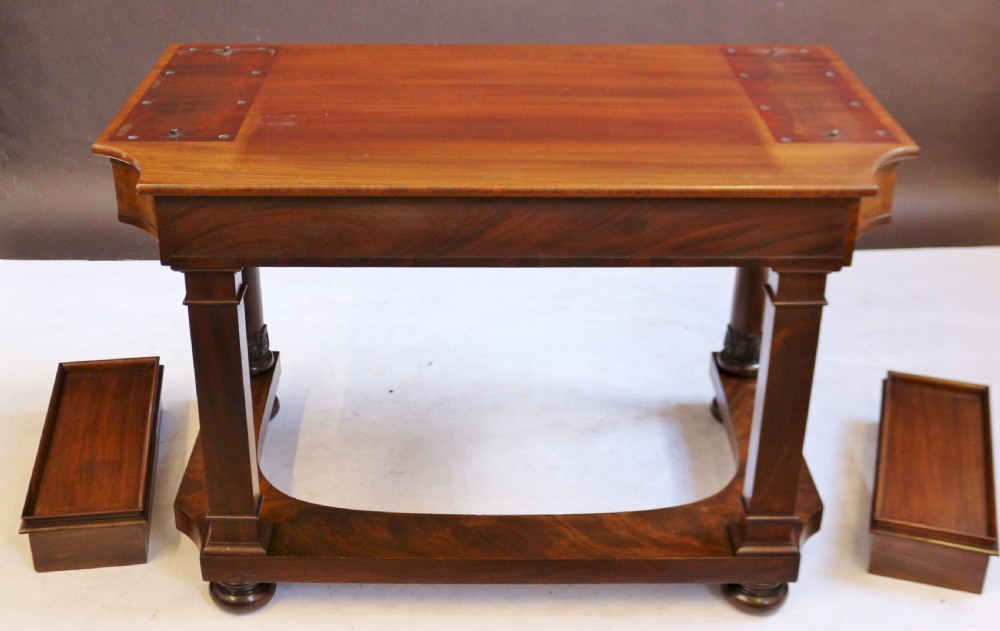 A William IV mahogany dressing table featuring an arched swivel mirror, brass sconces, upper drawers, and carved front columns on a plinth base. View XIV