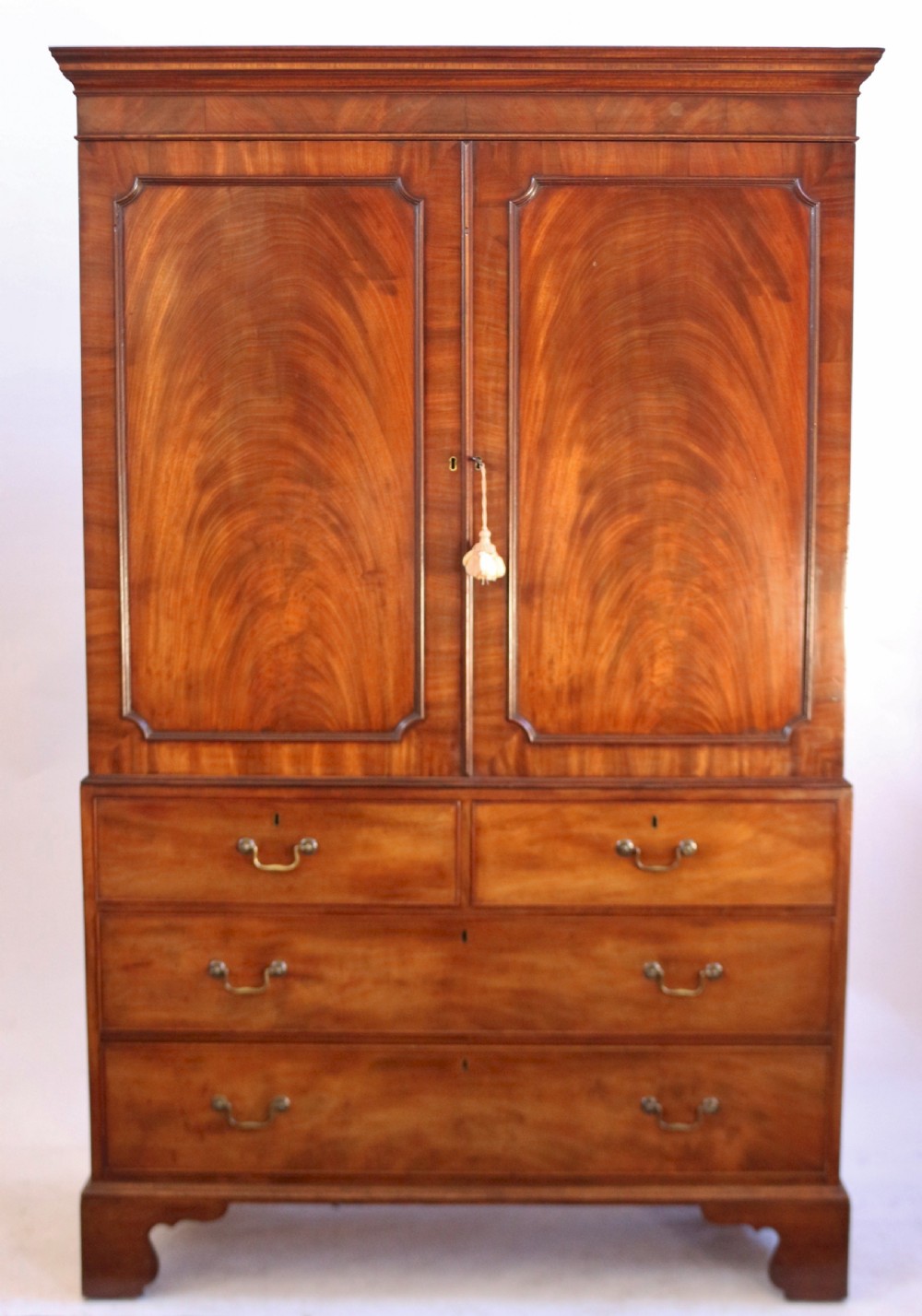 A Fine George 111 Figured Mahogany Linen Press with Sliding Trays