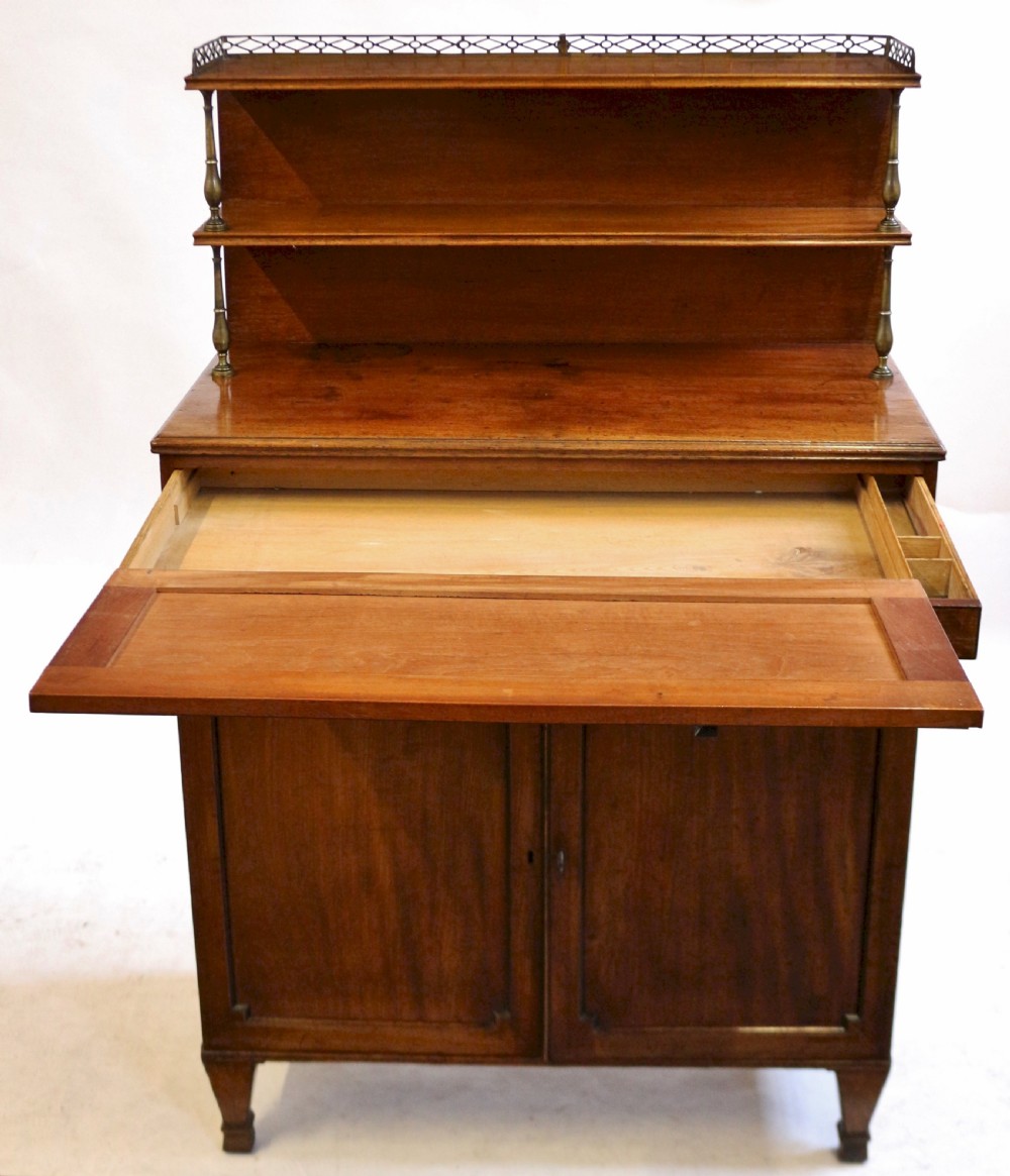 A Regency mahogany chiffonier with a two-tier brass-galleried shelf unit above a fitted writing drawer and two-door cabinet base. View III
