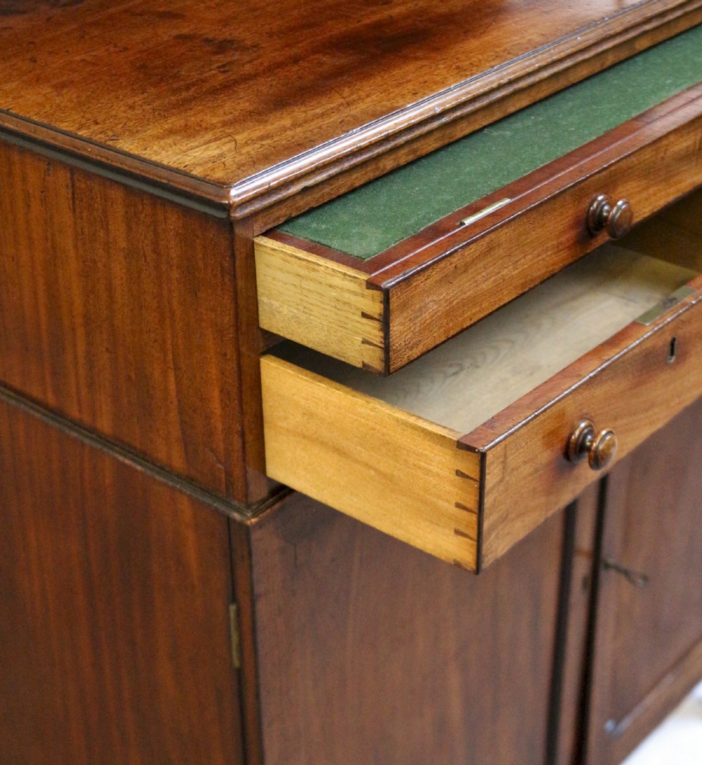 A Regency mahogany chiffonier with a two-tier brass-galleried shelf unit above a fitted writing drawer and two-door cabinet base. View XII