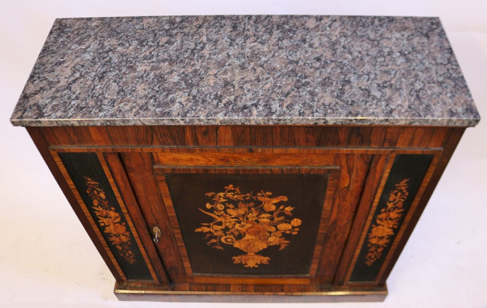 A Victorian rosewood side cupboard featuring an inlaid floral marquetry central door, flanking inlaid side panels, and a grey marble top. View III